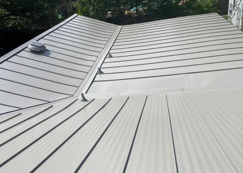 Solar attic fan installed on a metal roof for Roof Ventilation in Martinsville