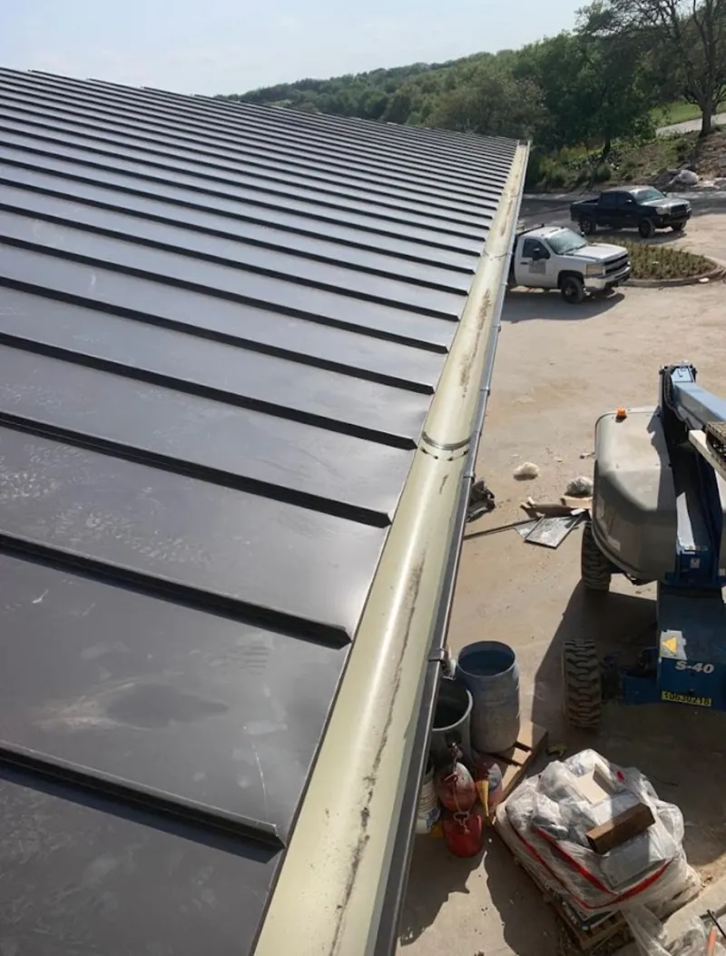 Standing seam panel and gutter detail on a metal roofing jobsite in Martinsville